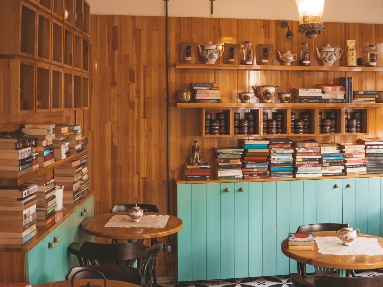 The PURRHAUS room: warm wood, a mint-green espresso bar and window seating