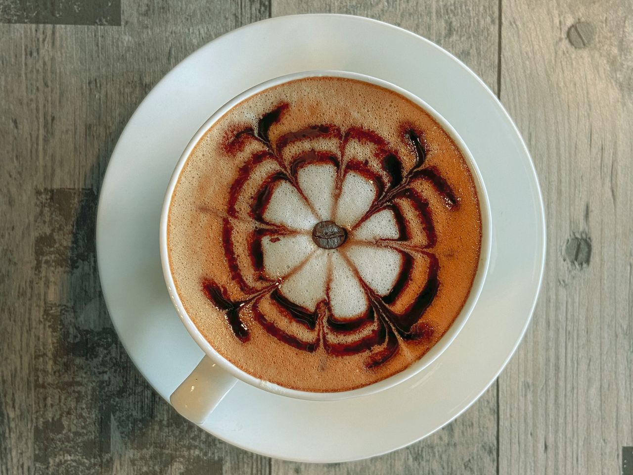 Top-down view of latte art poured into a flat white